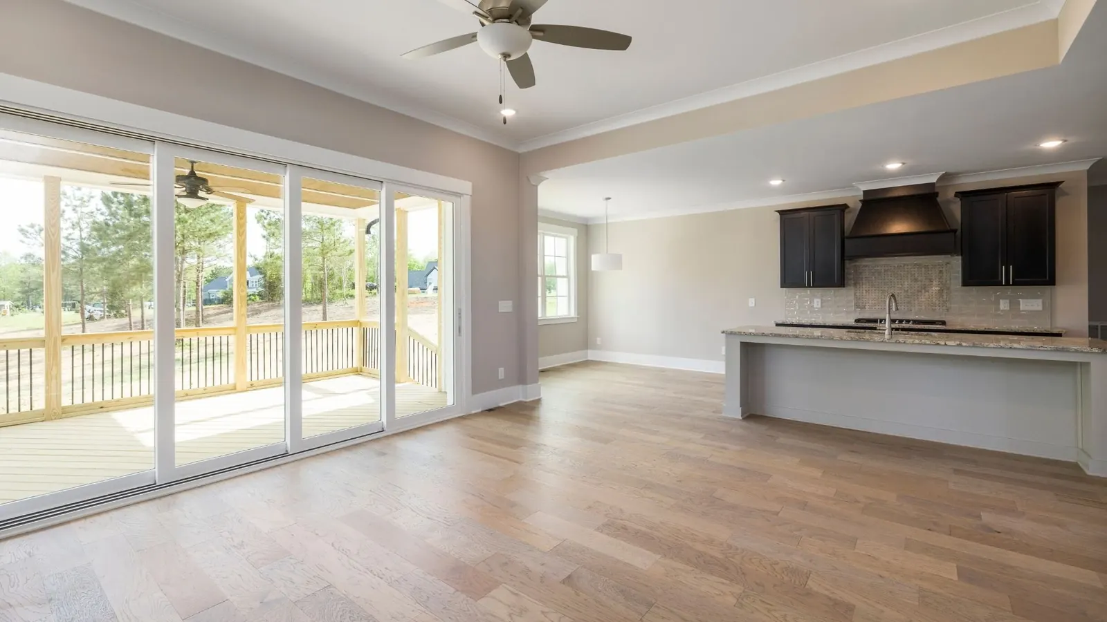 Clean open-concept living and kitchen space with polished floors